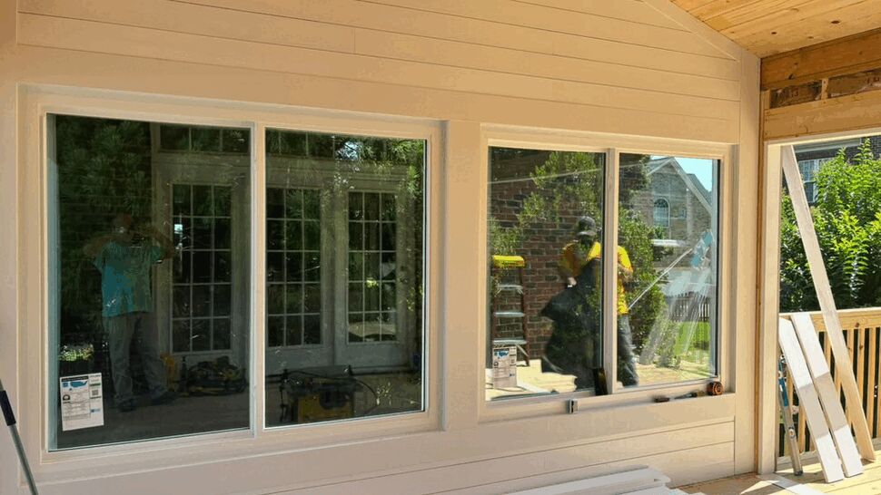 Interior view showing two sliding windows reflecting the outdoor scene