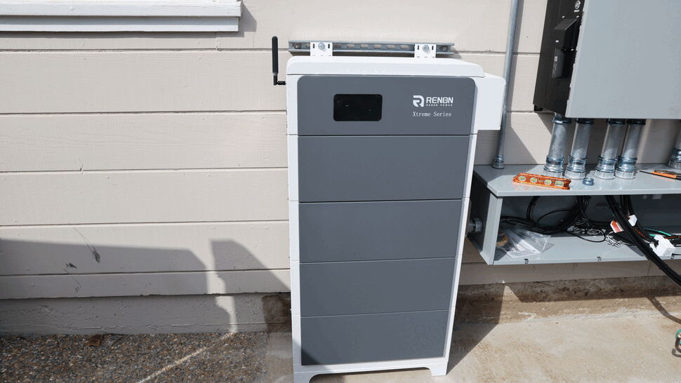 Battery Storage Unit | Green Air Heating & Air Conditioning Inc Grey Renon Xtreme Series battery storage cabinet mounted beside house