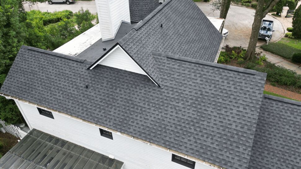 Aerial Multi-Gabled Asphalt Roof | Next Level Roofers Inc Aerial view of a large home with new gray asphalt shingle roof and white siding.