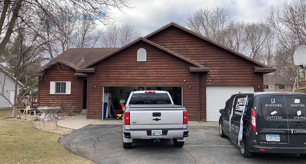 Front of house from BEFORE a Roofing, Gutters, Siding transformation.