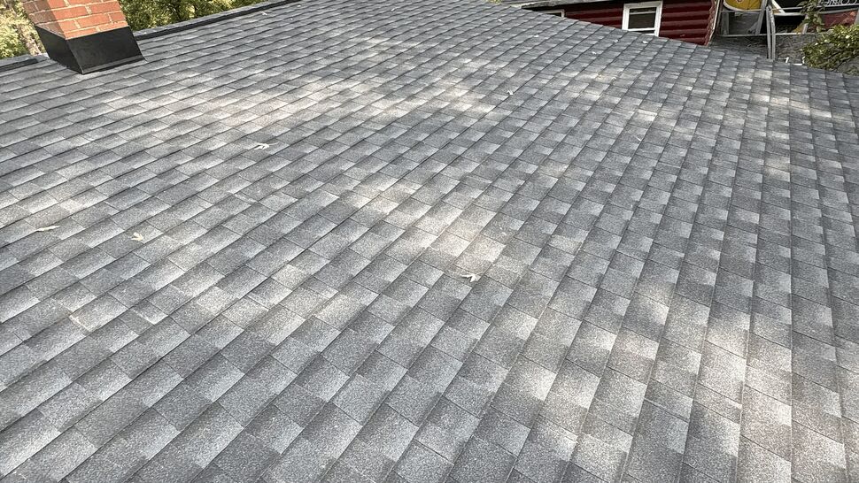 Asphalt Shingle Roof Close-Up | Lutgen Companies Close-up of gray asphalt shingle roof with chimney nearby