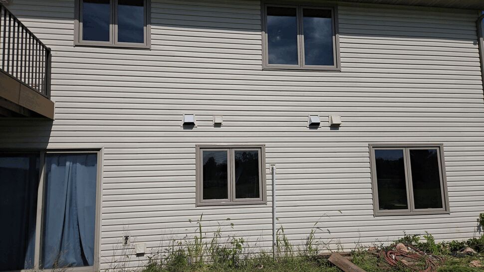 Rear vinyl siding and windows | Lutgen Companies New triple-pane replacement windows with tan frames installed in Big Lake, MN