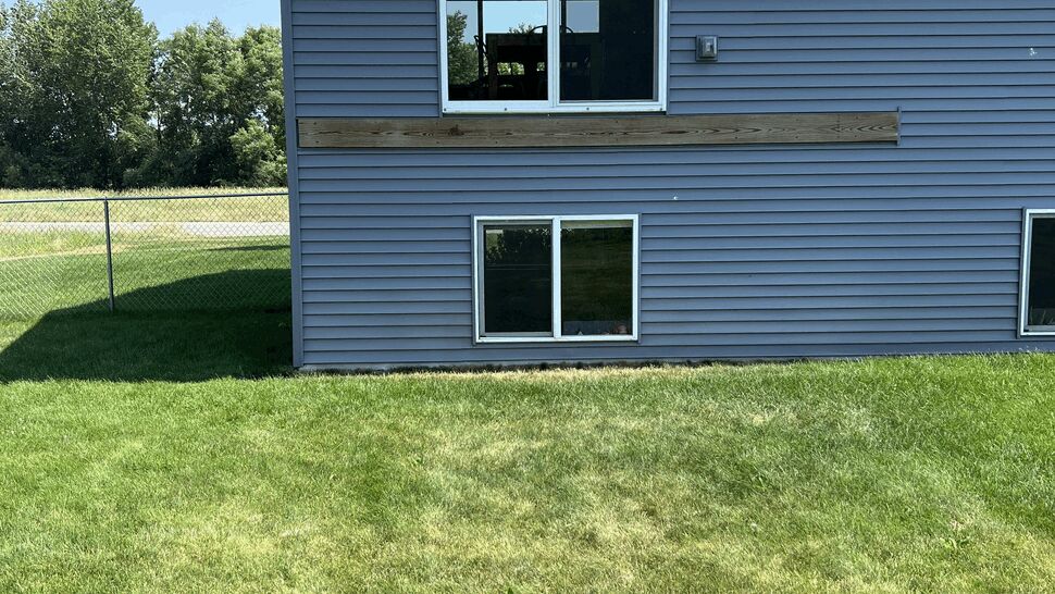 Before: split-level home in Rockville, MN with a ledger board in place and no deck off the sliding door