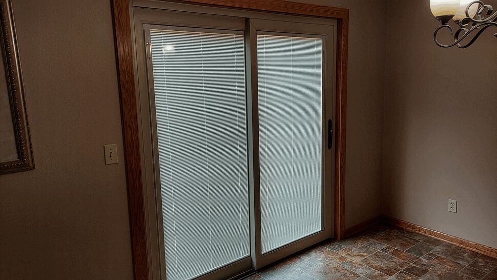 Interior view of a finished sliding glass door with integrated blinds.