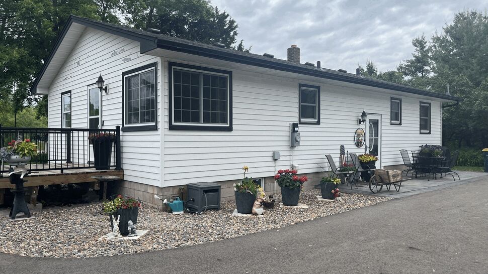 Finished White Siding and Windows | Lutgen Companies Finished white siding with black-trim windows and small deck