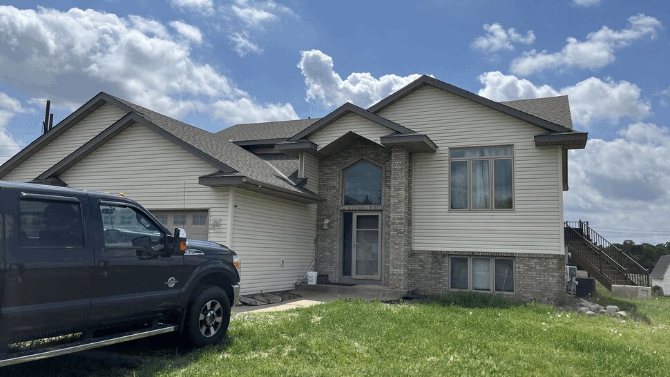 Front elevation with new rooflines | Lutgen Companies Aging sliding windows and patio door on a walkout-level home prior to window replacement in Big Lake, MN