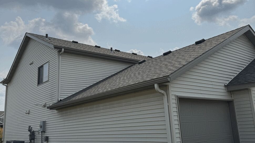GAF Timberline HDZ roofing on garage roof | Lutgen Companies Side view of house garage roof with gray GAF Timberline HDZ shingles and white gutters