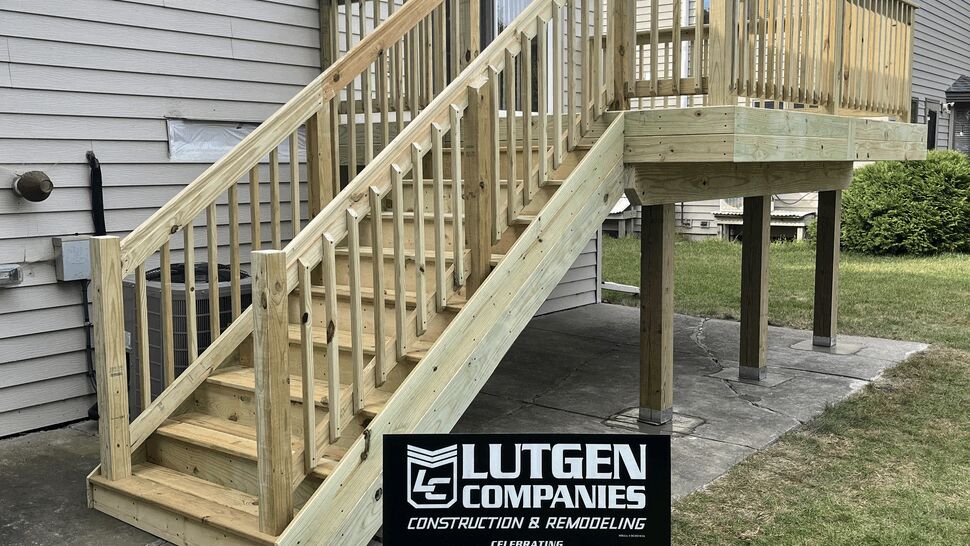New pressure-treated wood deck with vertical baluster railing and stairs in St. Cloud, MN