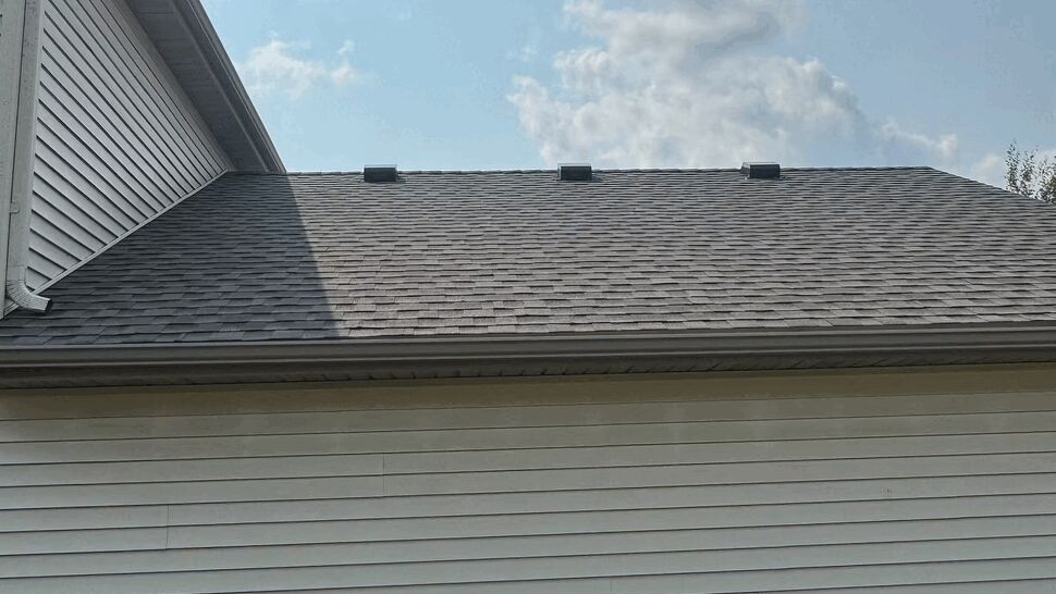 Roof slope with ridge vents and gutter along the eave