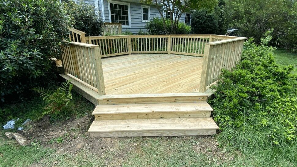 New Railed Backyard Deck | Exterior Source Virginia New backyard deck with wide steps, treated lumber boards, and wood railings