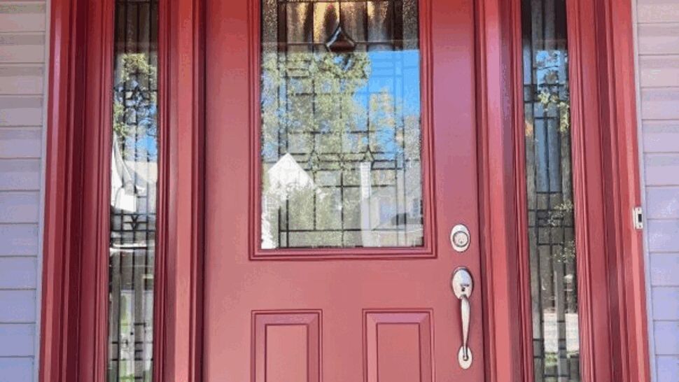 Red front door with decorative glass and matching sidelights