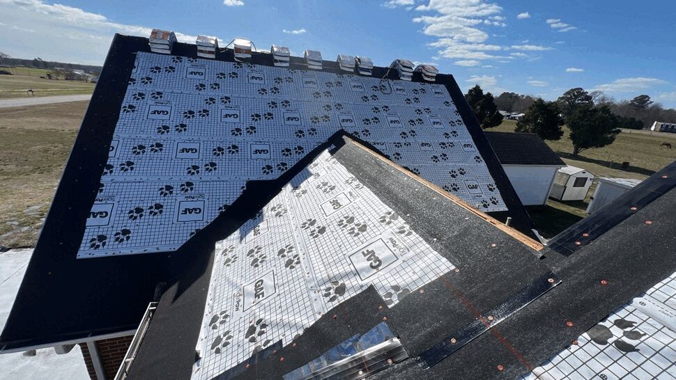 Roof deck covered with GAF underlayment and flashing during a reroofing project