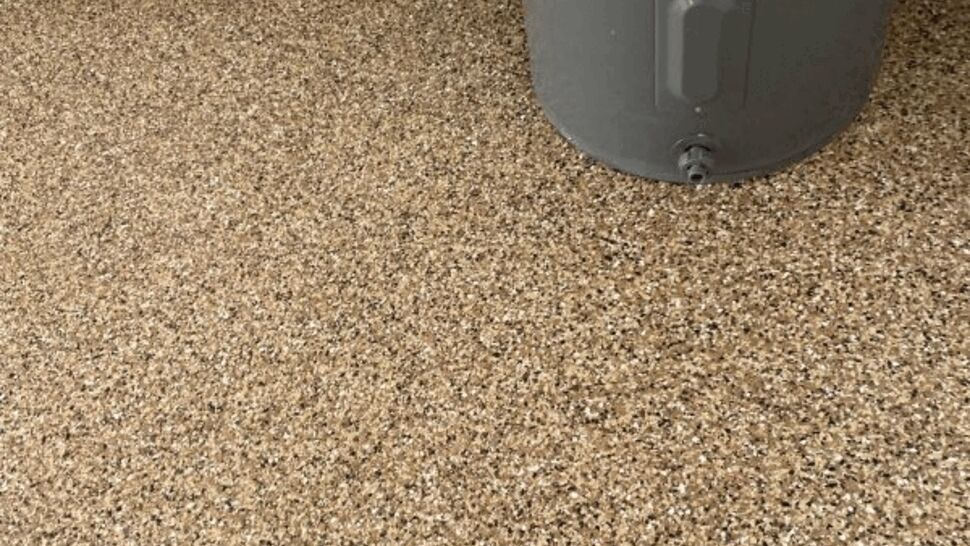 Close-up of speckled epoxy concrete coating next to a water heater.