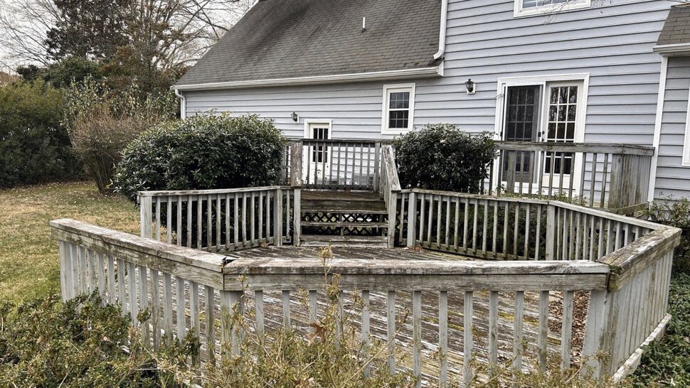 Weathered Backyard Deck Before | Exterior Source Virginia Weathered backyard deck with faded railings and stairs beside a gray home