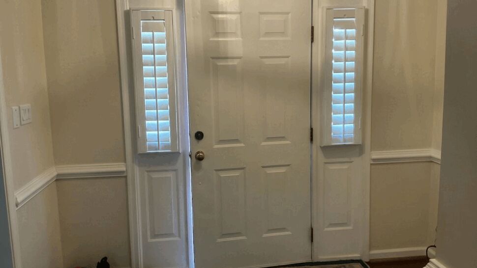 White entry door with shuttered sidelights inside a foyer