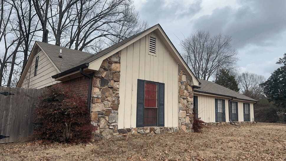 Gable end with window, stone accents and roofline in winter