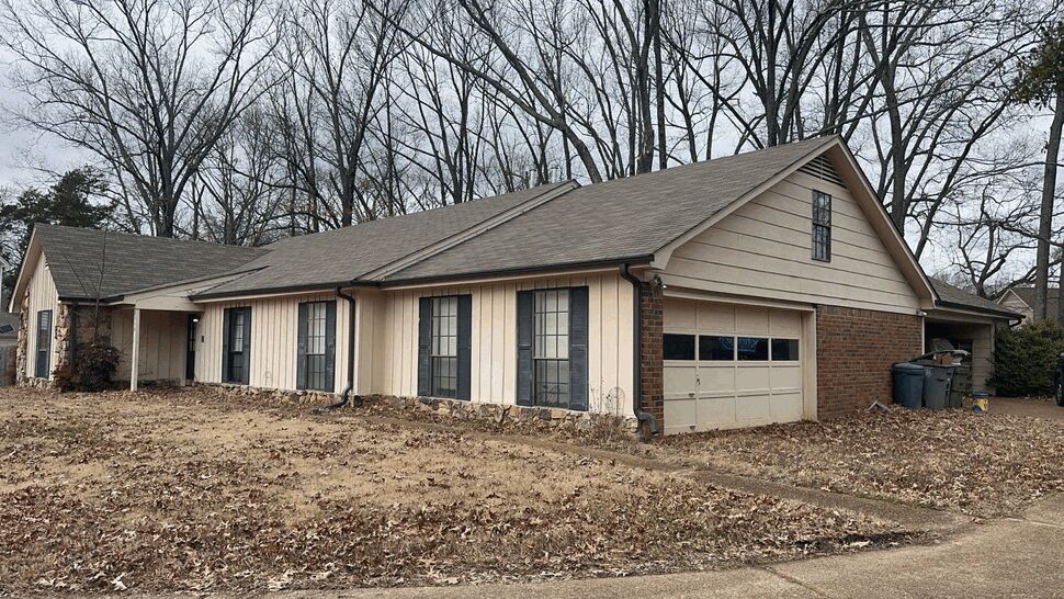 Side view of house garage with visible gutters and downspouts