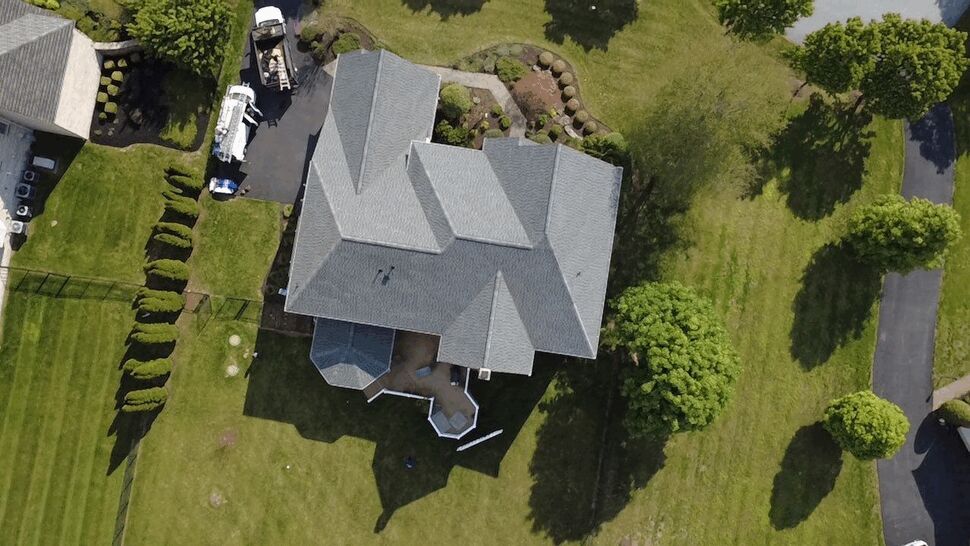 Aerial Gray Shingle Roof | Wells Home Improvements Aerial view of a gray shingle roof on a landscaped residential property.