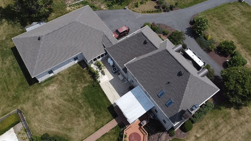 Aerial view of a large residential roof with multiple sections