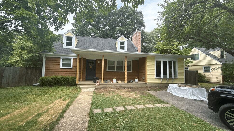 Cape Cod house with covered front porch, asphalt roof and mixed siding
