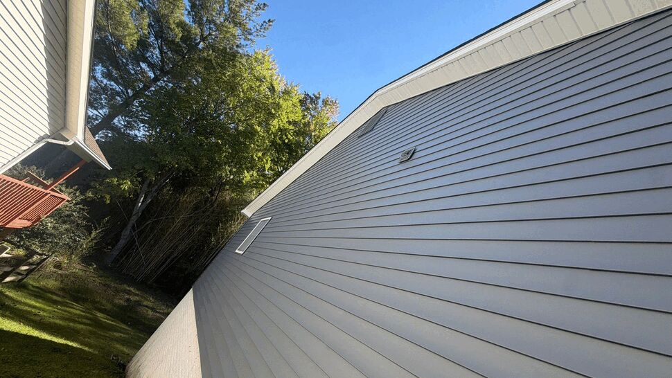 Close-Up Vinyl Siding Detail | Wells Home Improvements Close view of light gray vinyl siding on a home gable.