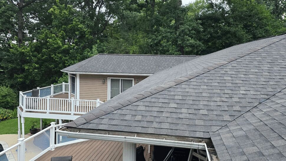 Gutter Above Deck and Roofline | Wells Home Improvements Gutter along roofline above white deck railing and pool area