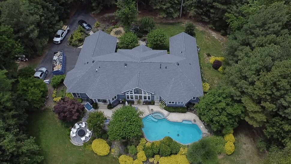 Estate Roofing and Pool | Wells Home Improvements Overhead view of a large gray roof with a pool and landscaped grounds.