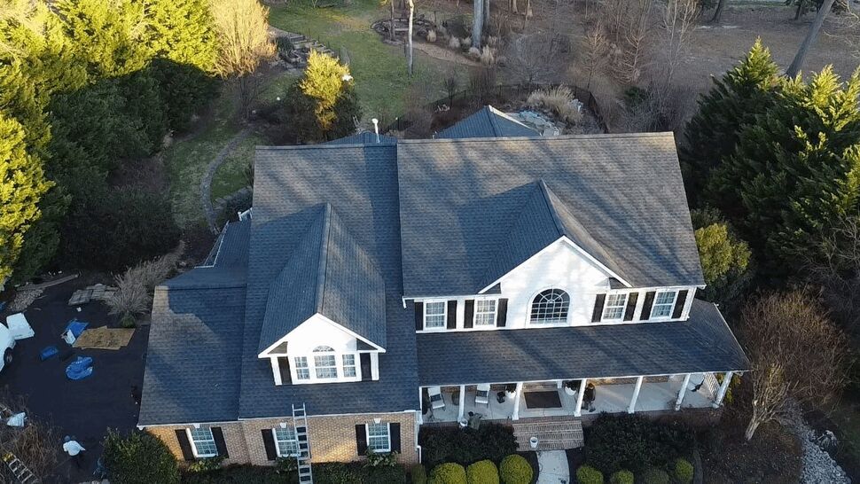 Front Dormer Roof Aerial | Wells Home Improvements Aerial view of a two-story house with gray shingle roof and a front dormer.