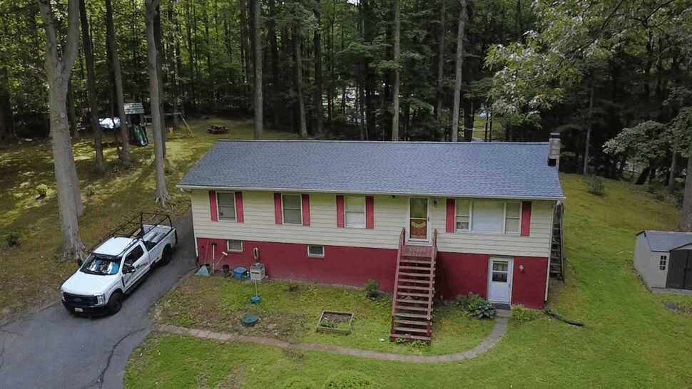 Front elevation of home with dark gray shingle roof after installation by Wells Home Improvements