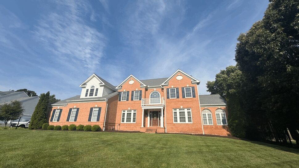 Wide view of house front showing windows, siding, and roofline