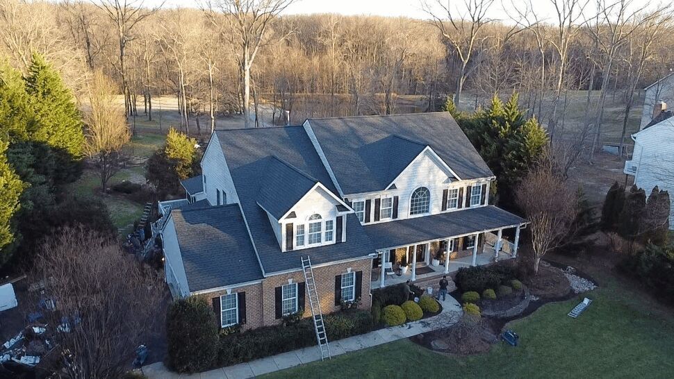 Full Property Roof Aerial | Wells Home Improvements Wide aerial of the entire property showing the home's roof and surrounding trees.