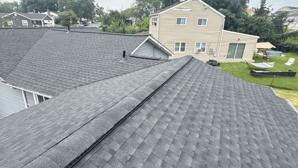 Gray shingle roof with ridge vent | Wells Home Improvements Close-up of gray asphalt shingle roof and ridge vent