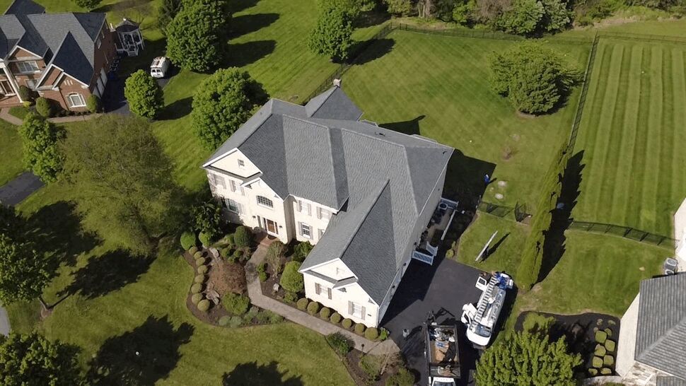 Landscaped Home Roof View | Wells Home Improvements Aerial view of a large landscaped home with a detailed gray shingle roof.