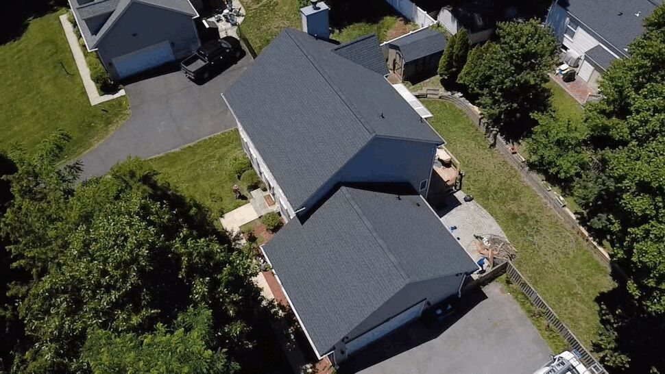Overhead shot of house and garage roofs | Wells Home Improvements Overhead drone shot of house and detached garage with coordinated shingle roofs