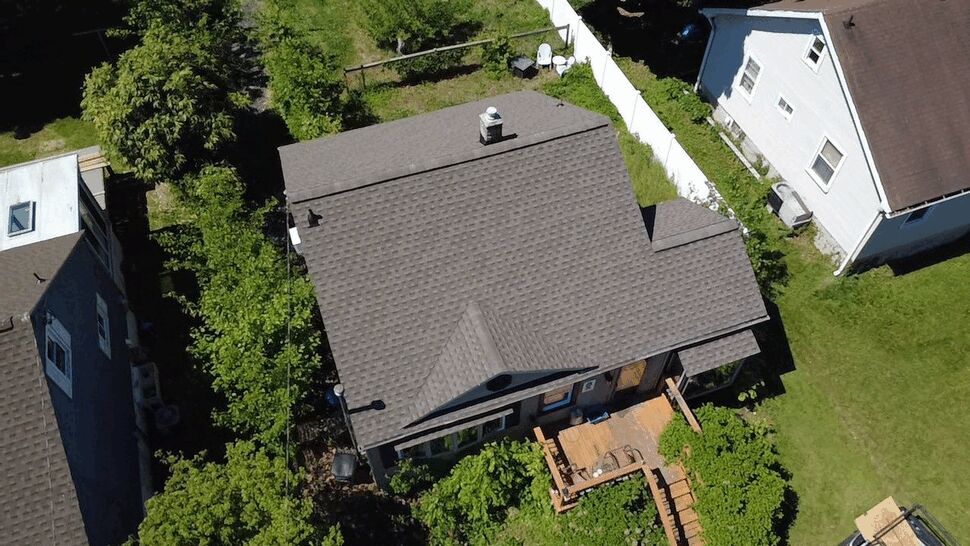 Overhead Roof Shingle View | Wells Home Improvements Top-down view of a shingled roof and surrounding yards