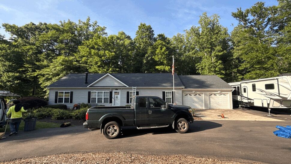 Ranch Home Roof Service | Wells Home Improvements Single-story ranch house front with pickup truck and ladder for roof work