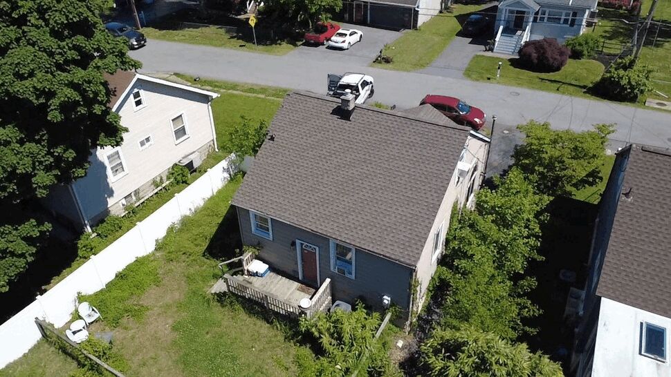 Rear Yard Siding and Roof | Wells Home Improvements Rear yard view of a small house showing siding and roof