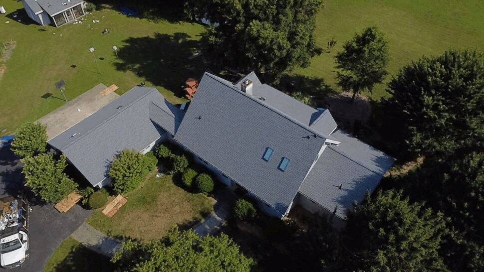 Skylights and Shingle Roof | Wells Home Improvements Drone image of house roof featuring two skylights and new shingles.