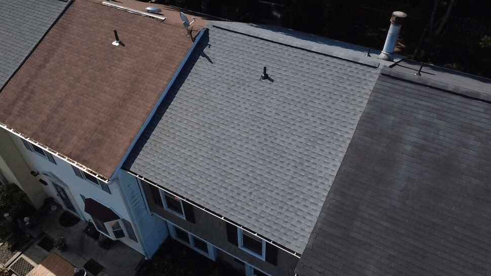 Three Adjacent Rowhouse Roofs | Wells Home Improvements Aerial shot of three adjacent roofs in different shingle colors on rowhouses.